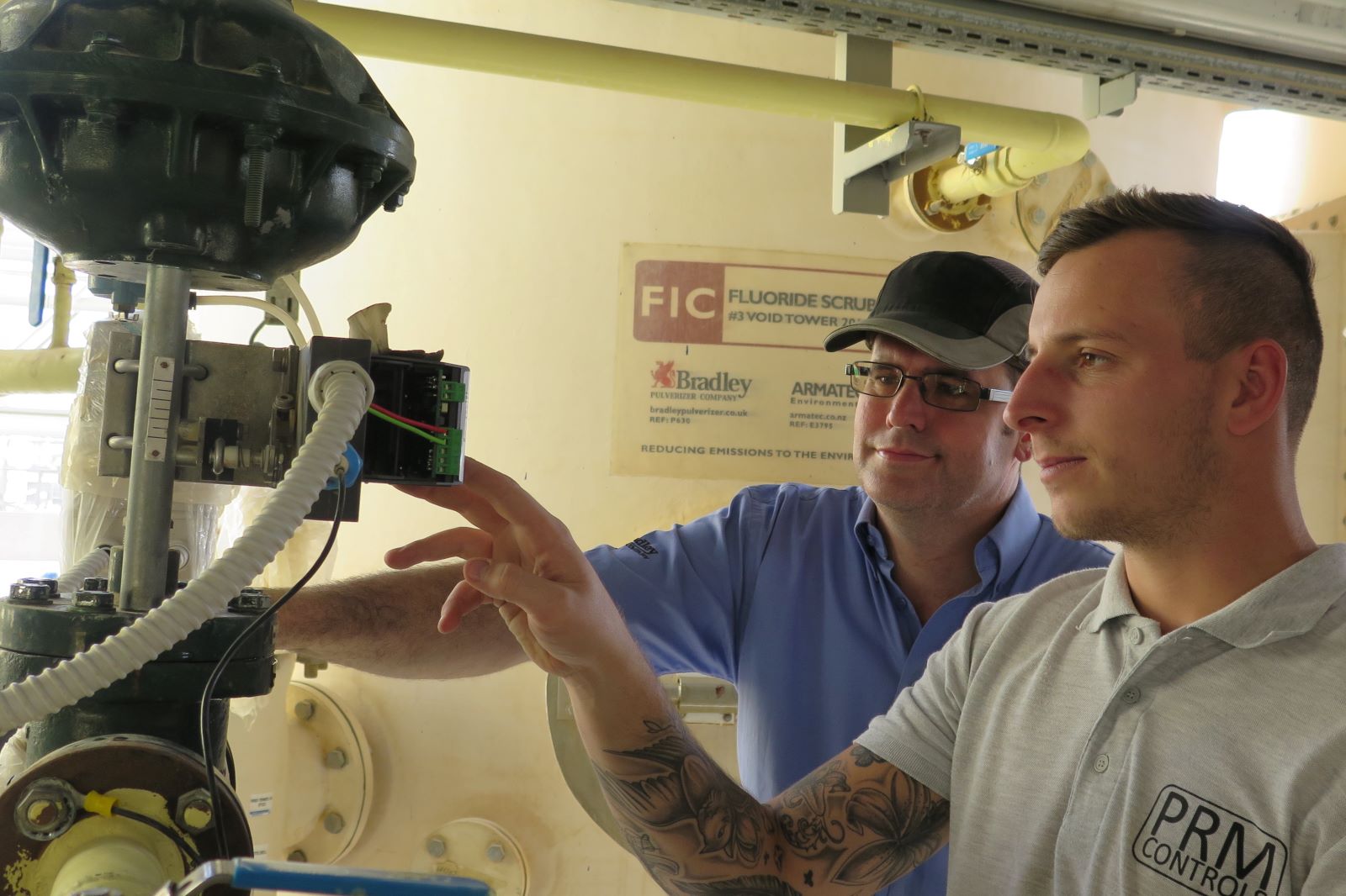 Two men examining a machine